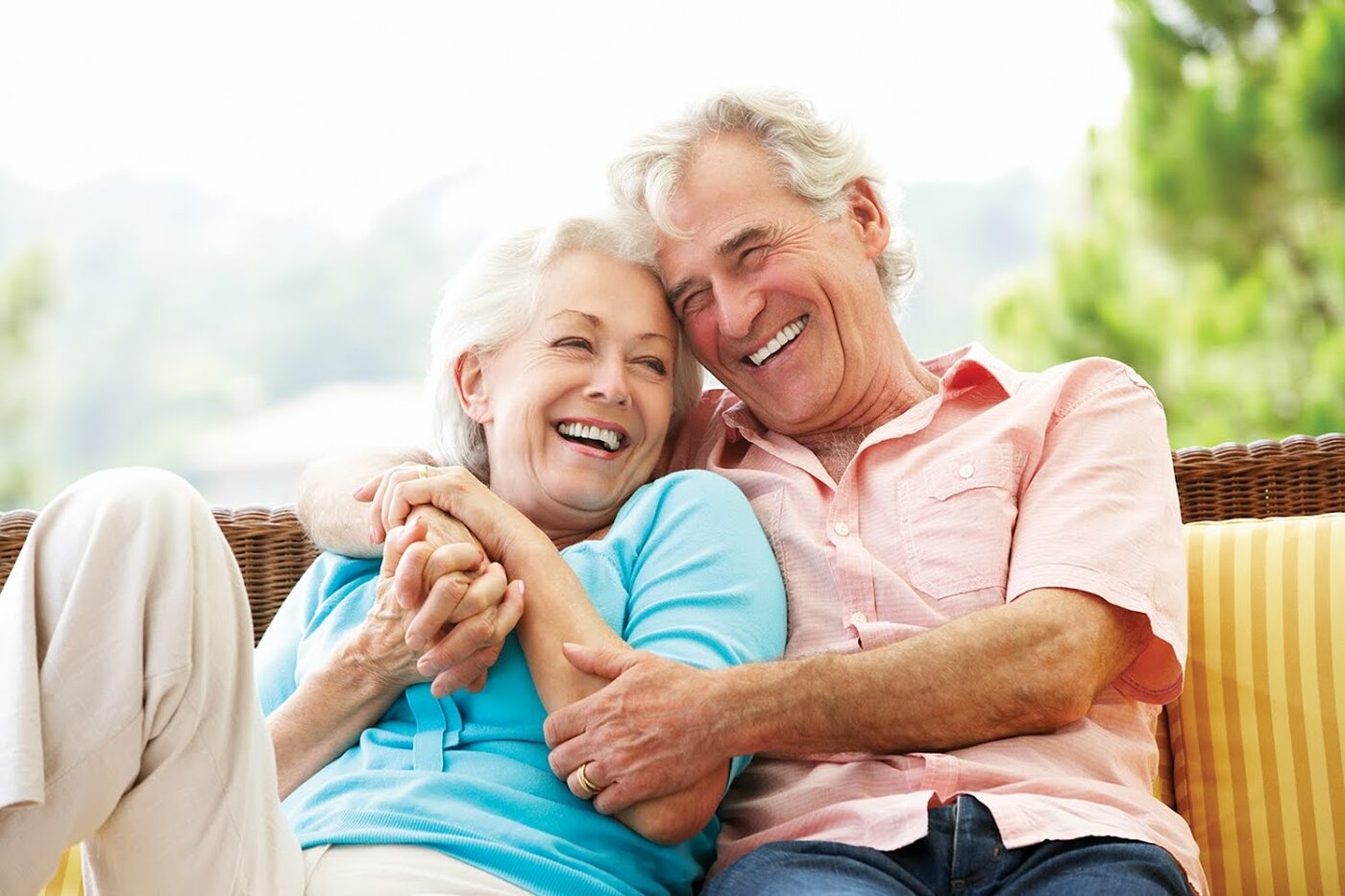 Senior couple laughing together after restorative dental treatment