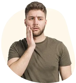 Man holding his cheek in pain from a dental abscess