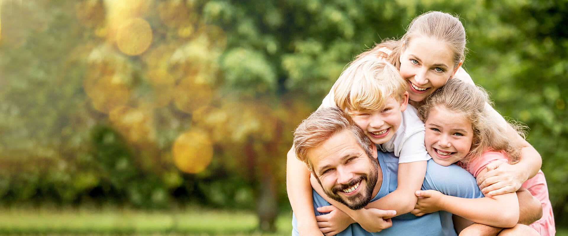 Smiling family of four outdoors