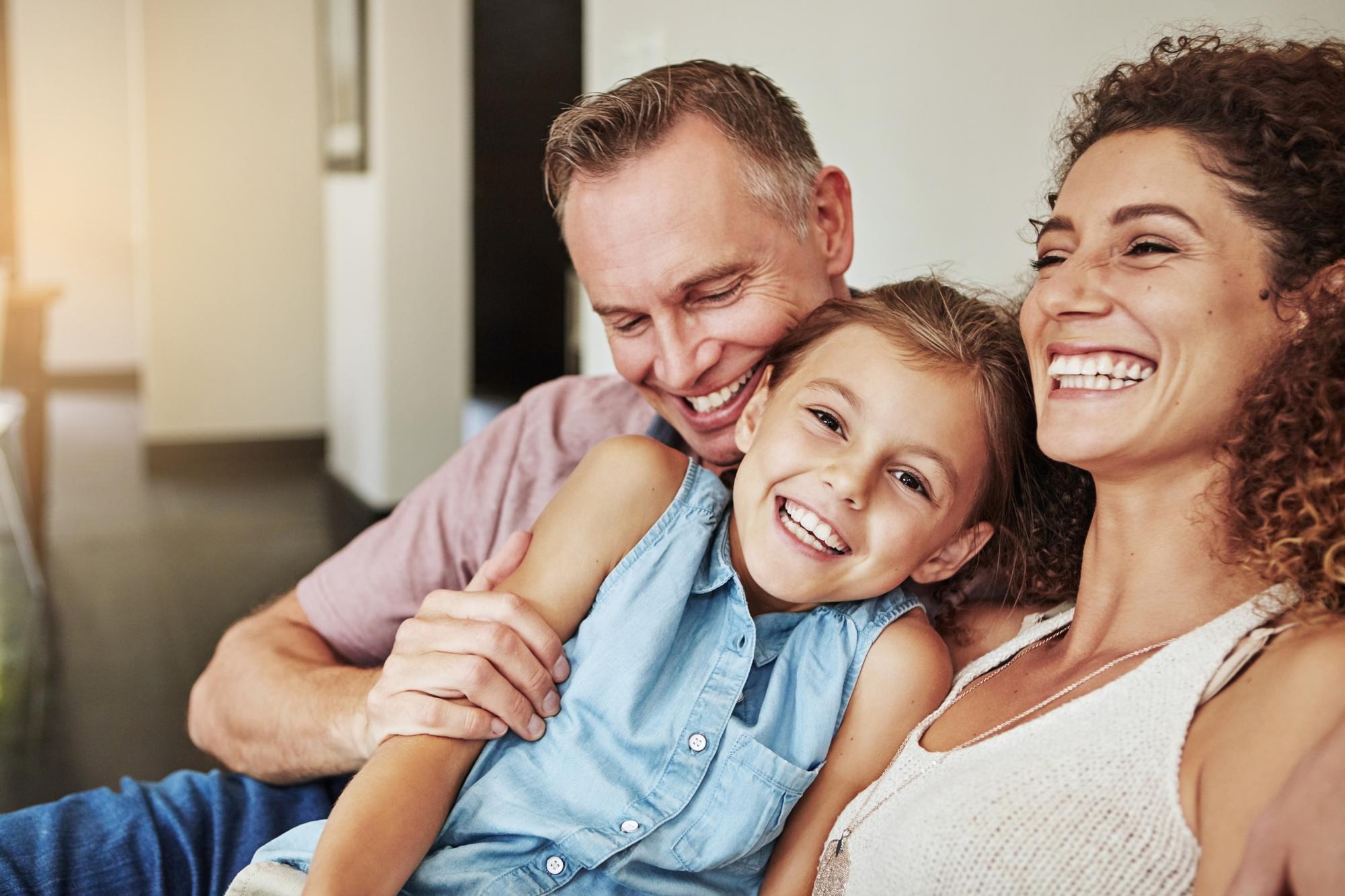Happy family of three smiling together